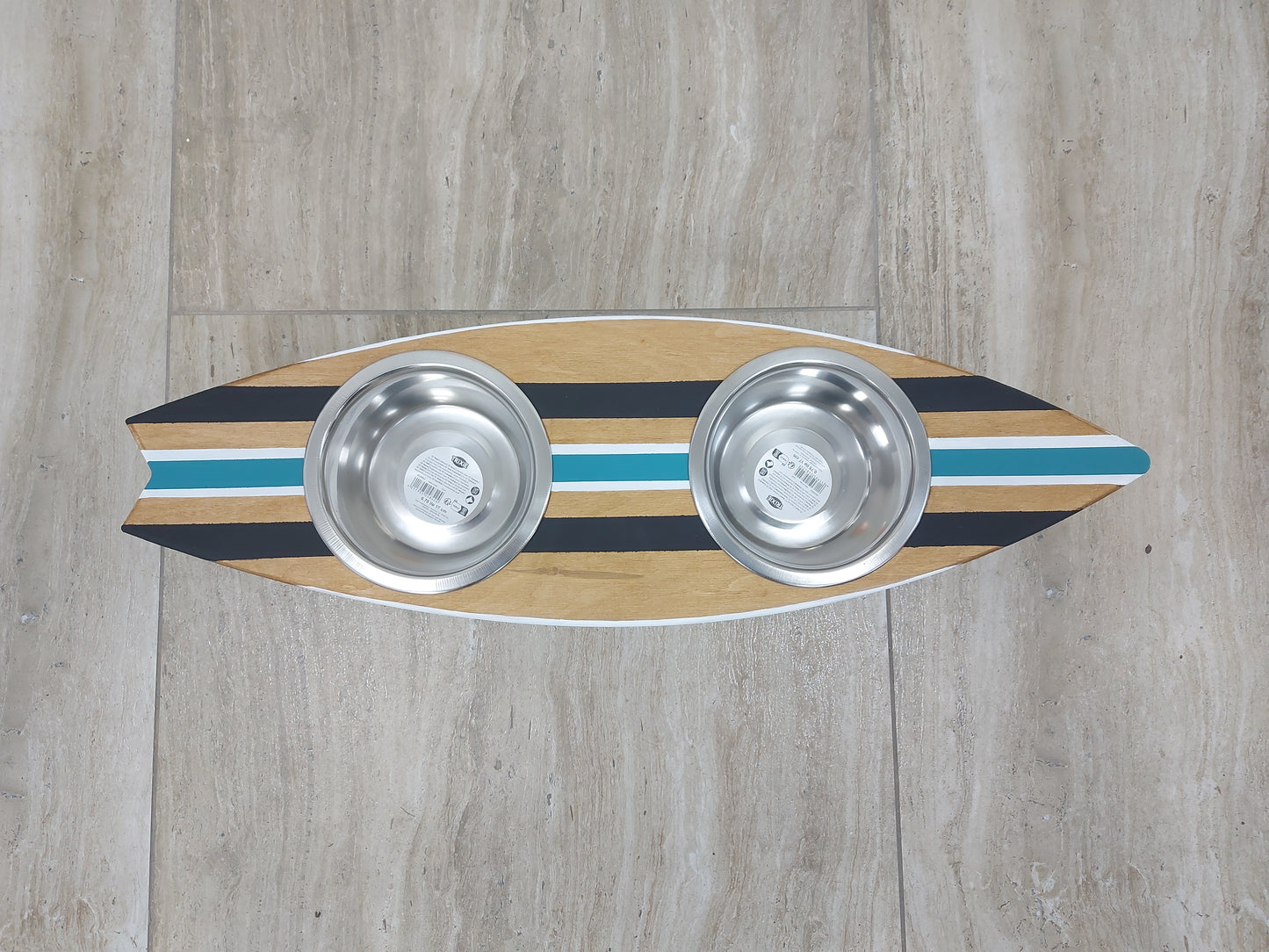 Handmade surfboard dog feeder styled in coastal home interior