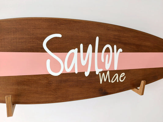 Close-up of engraved name on custom wooden surfboard wall art