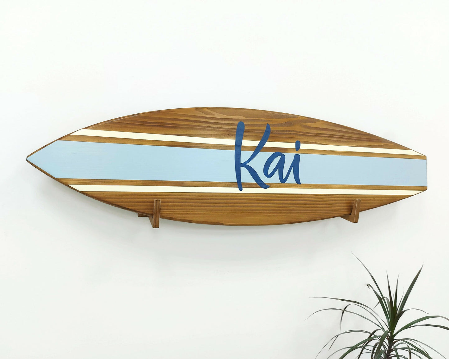Personalized wooden surfboard name sign hanging in nursery room