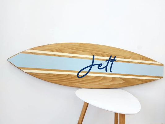 Close-up of engraved name on handcrafted surfboard wall art