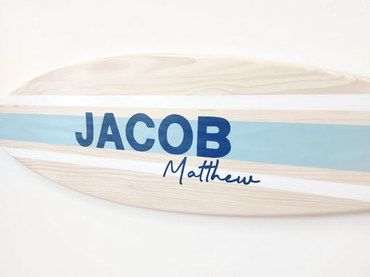 Close-up of engraved name on handcrafted surfboard sign