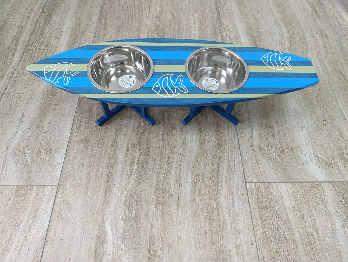Coastal-inspired pet feeding stand shaped like a surfboard in home setting
