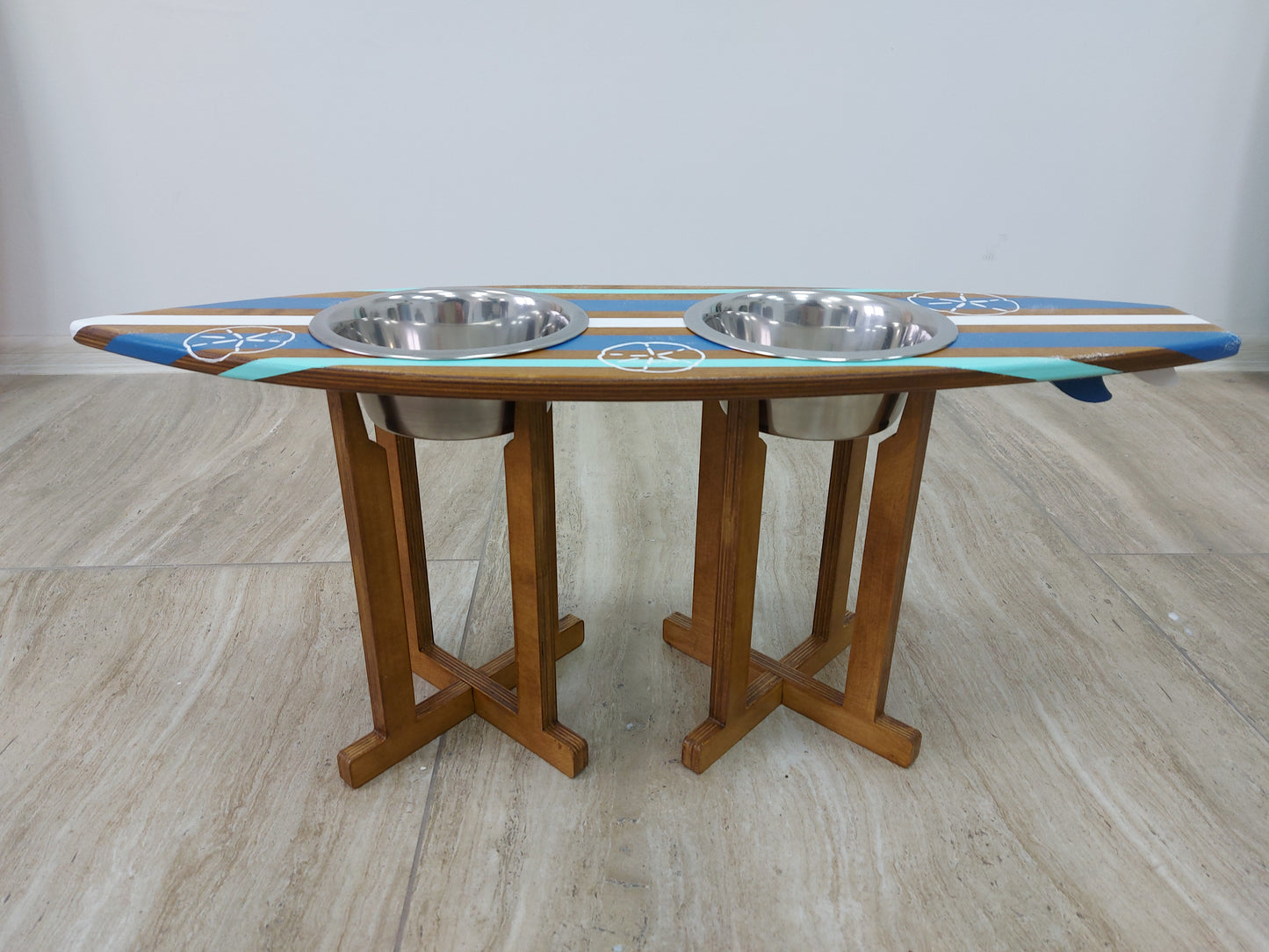 Surfboard dog feeding station styled in coastal home interior