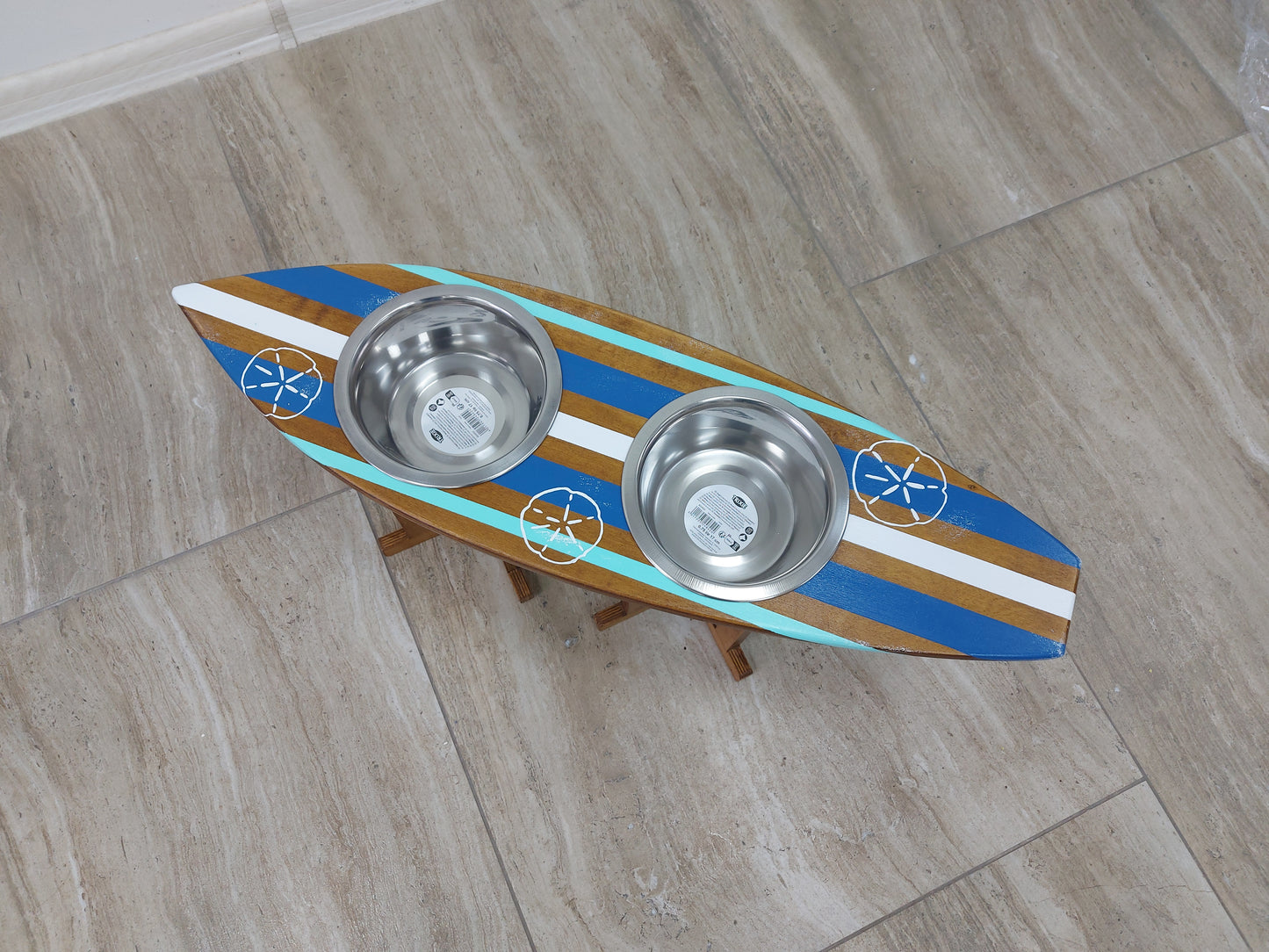 Close-up of custom surfboard pet feeding stand