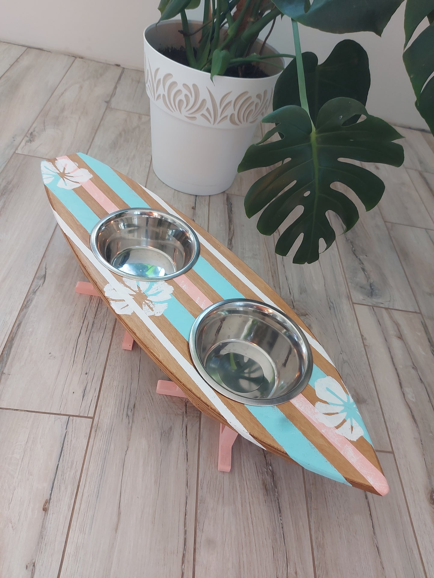 Personalized pet feeding stand placed on floor with dog food and water