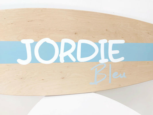 Close-up of engraved name on handcrafted surfboard wall art