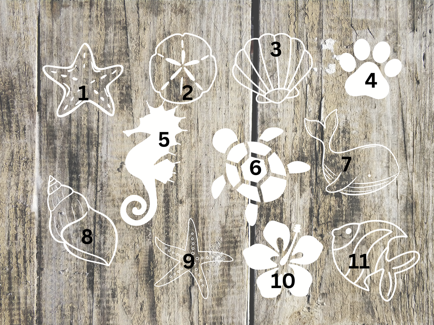 Set of white animal and nature-themed stencils on a wooden background