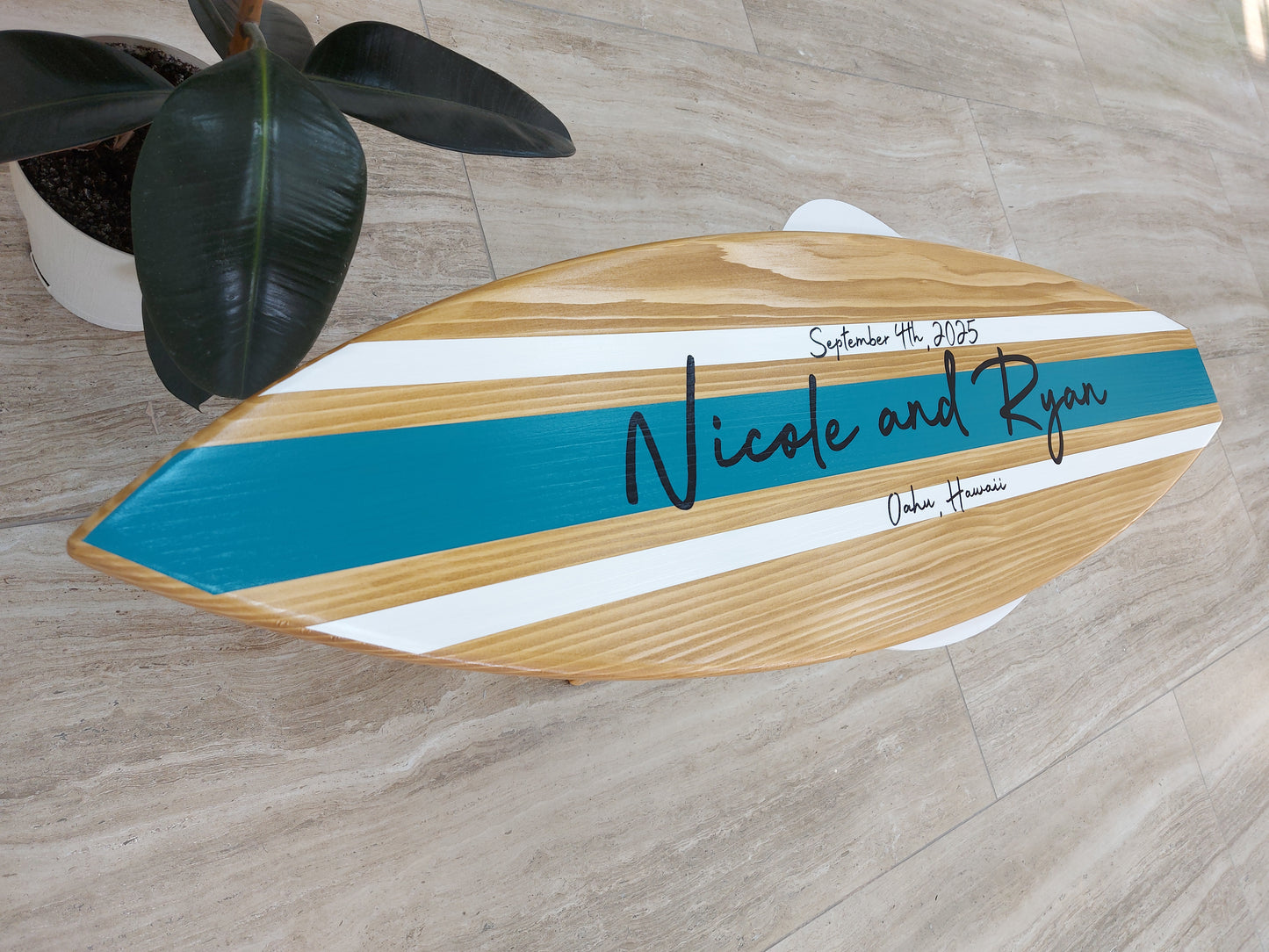 Guests signing wooden surfboard wedding guest book alternative