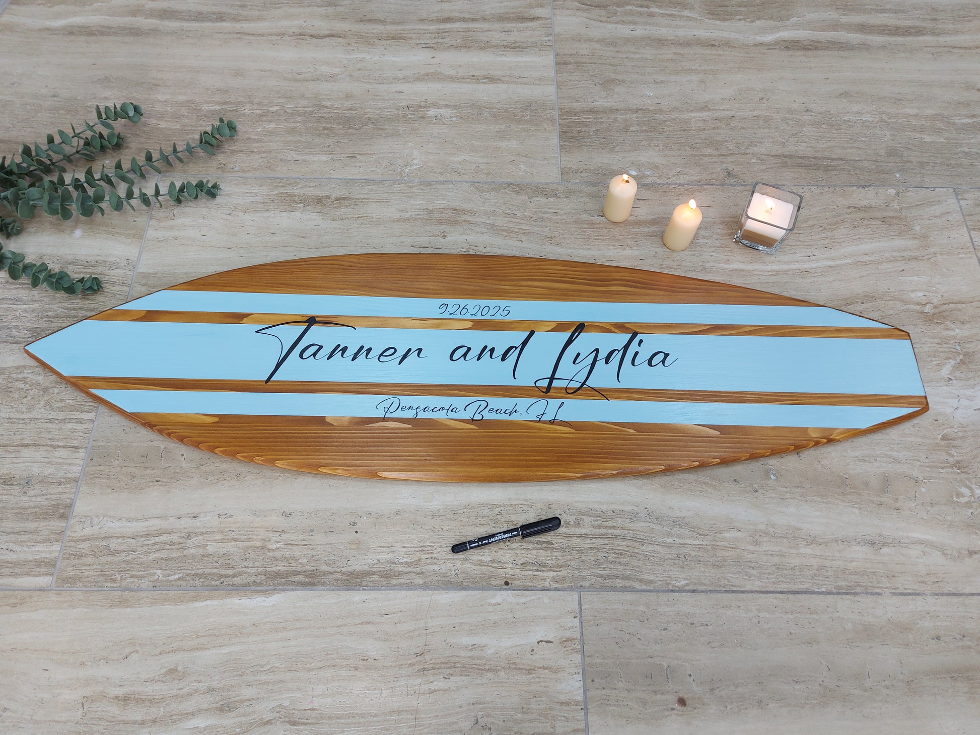Surfboard alternative guest book wedding sign displayed at reception