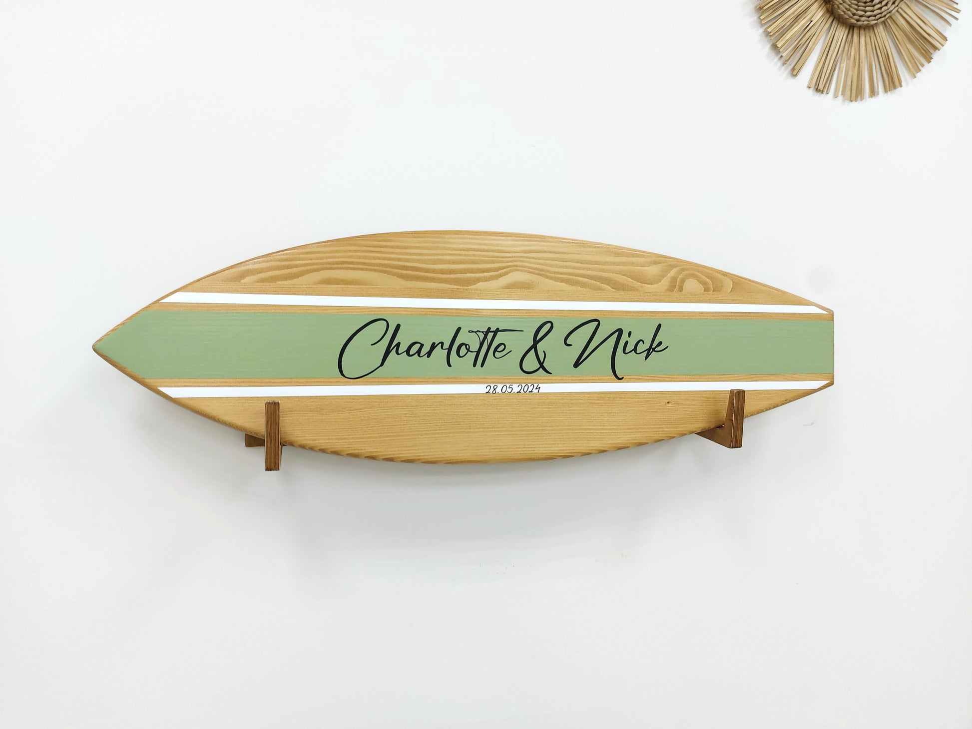 Guests signing surfboard guest book alternative at beach wedding