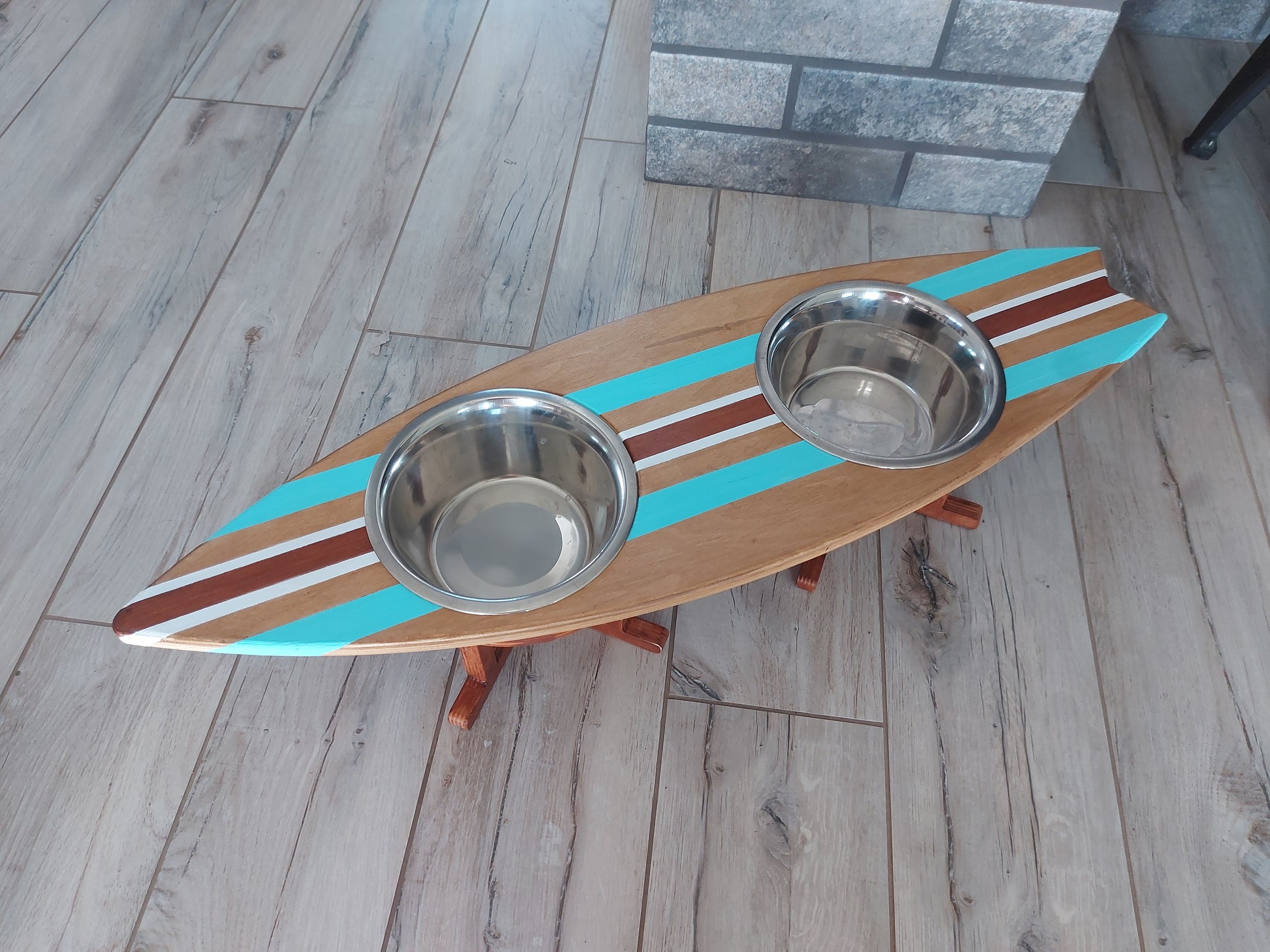 Close-up of custom painted surfboard pet feeding stand