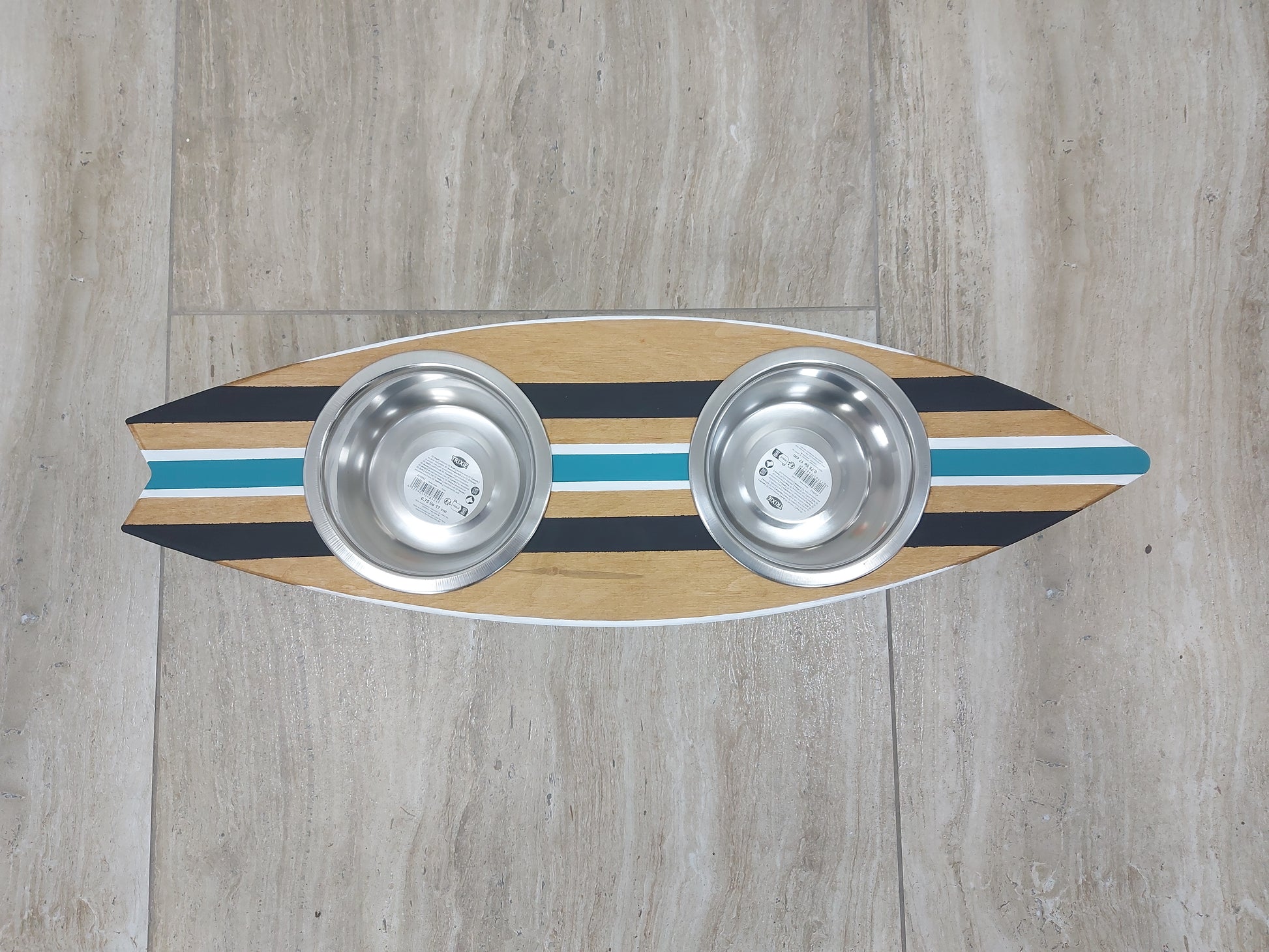 Handmade surfboard dog feeder styled in coastal home interior