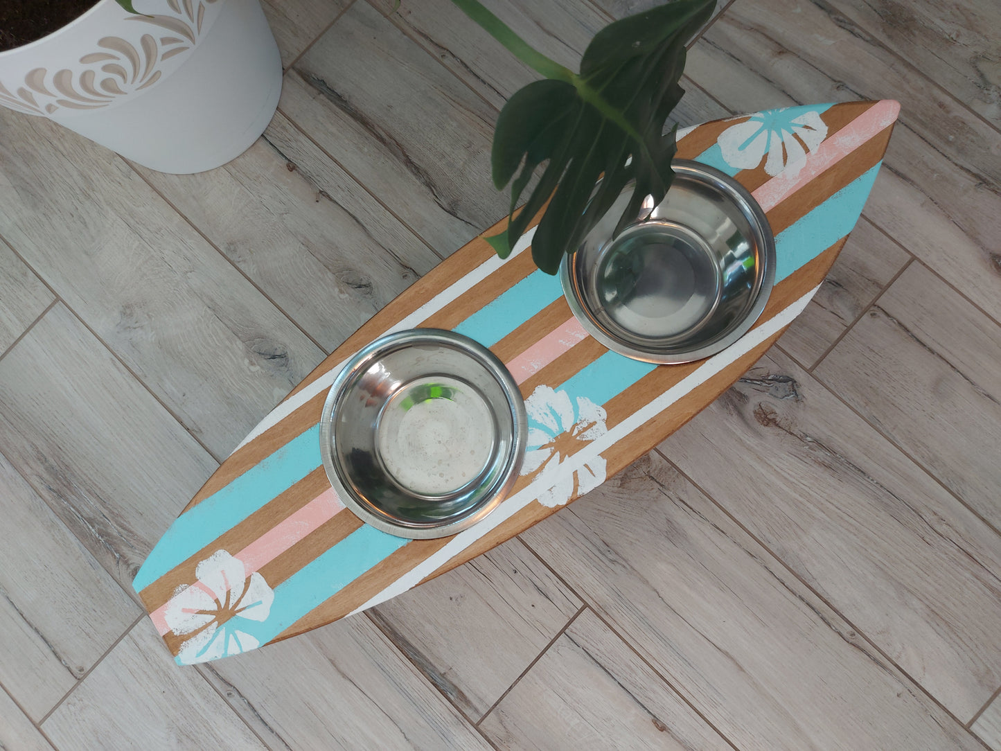 Close-up of custom painting on surfboard pet bowl holder