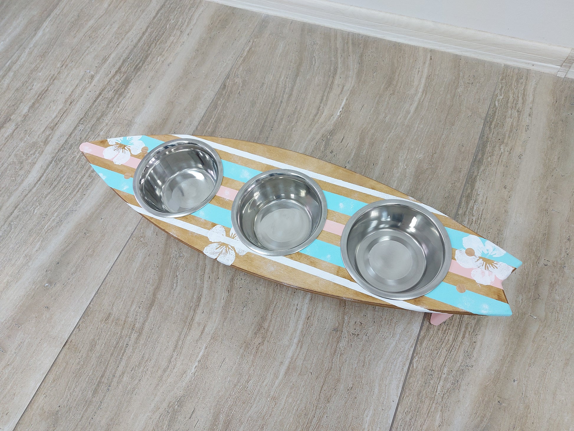 Handmade surfboard dog feeder styled in coastal home decor