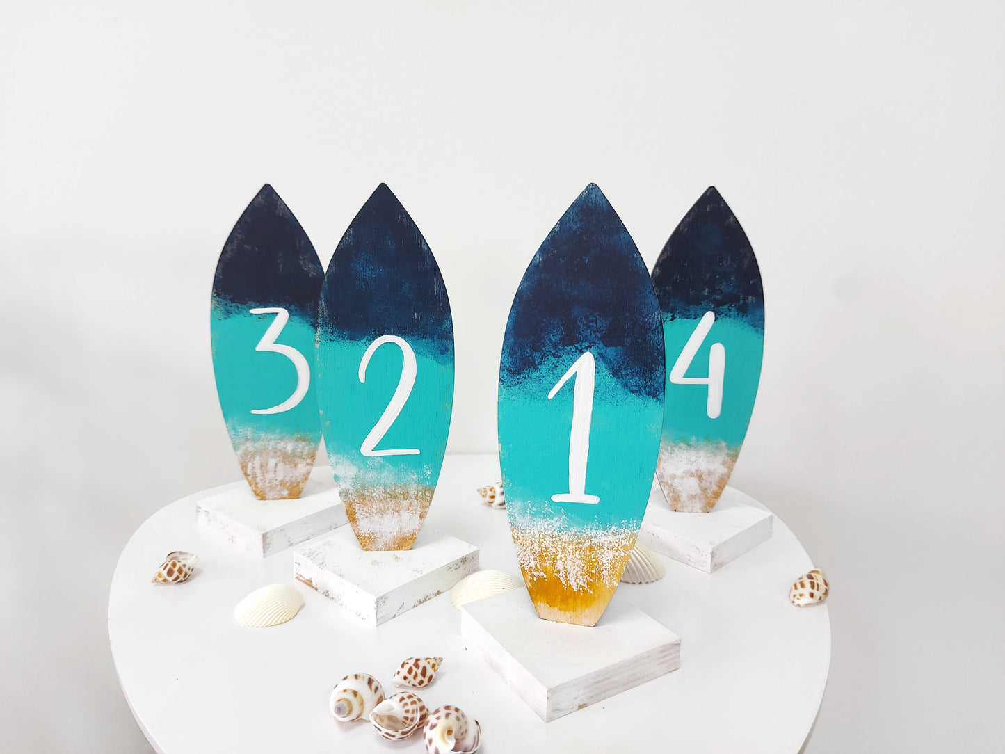 Beach wedding décor table numbers with surfboard design