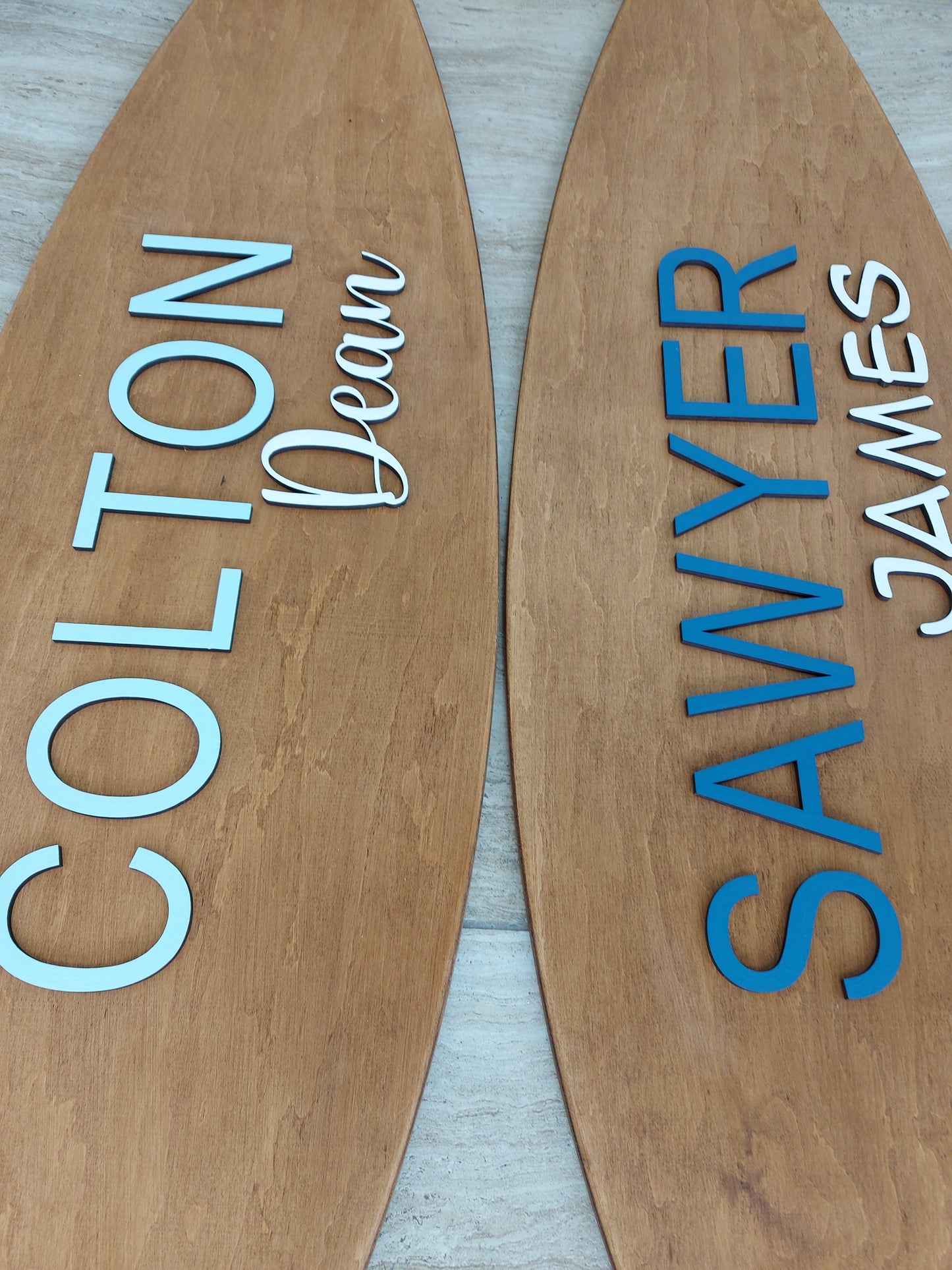 Surfboard name plaque styled in surf-themed kids’ room