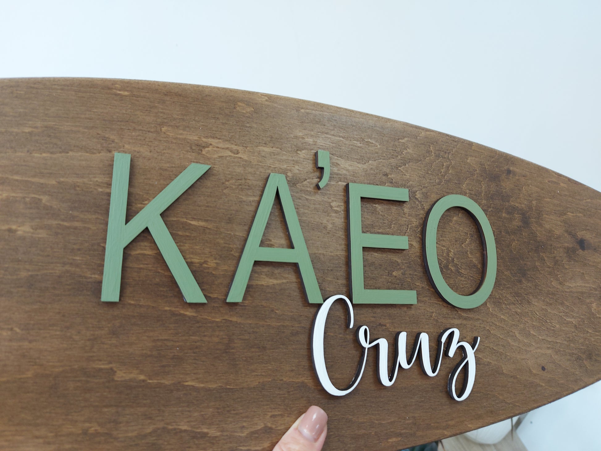Close-up of custom name on wooden surfboard decor