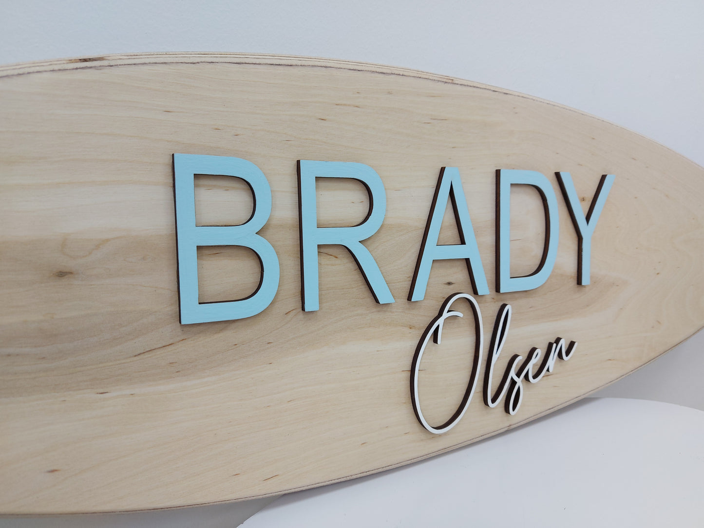 Close-up of 3D name on handcrafted surfboard wall art