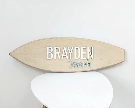 Personalized wooden surfboard sign with raised 3D letters on wall