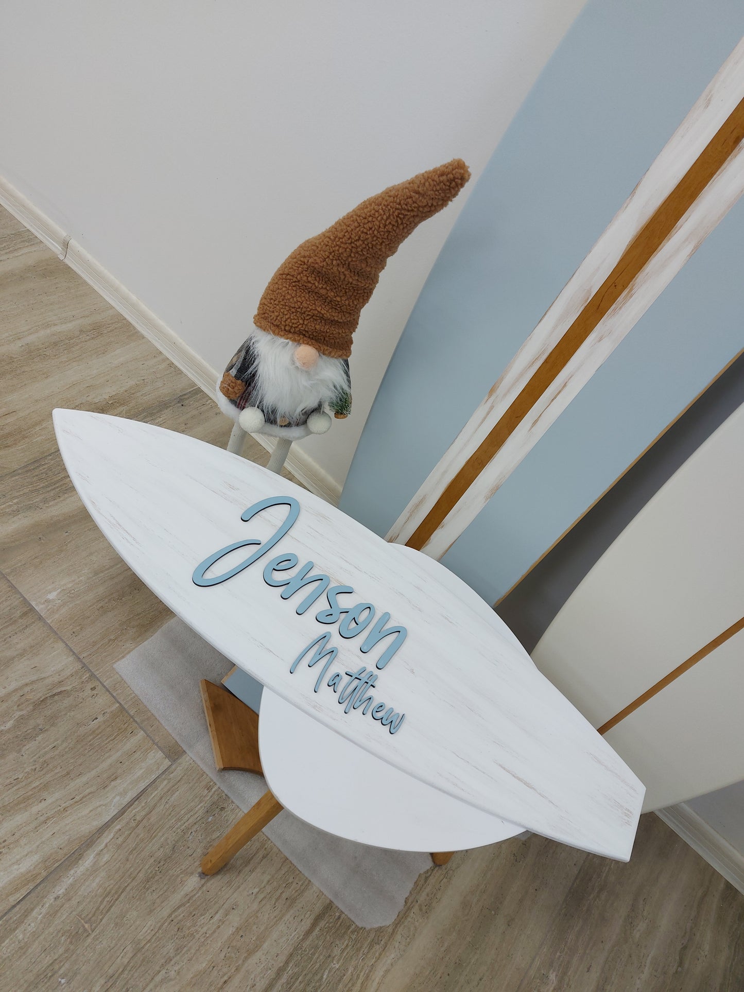 Coastal-style nursery with handcrafted surfboard name decor
