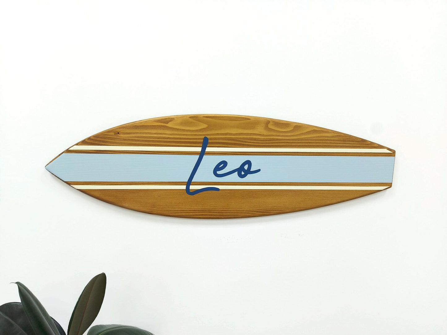 Custom baby name surfboard sign styled in beachy interior