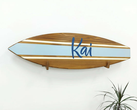 Personalized wooden surfboard name sign hanging in nursery room