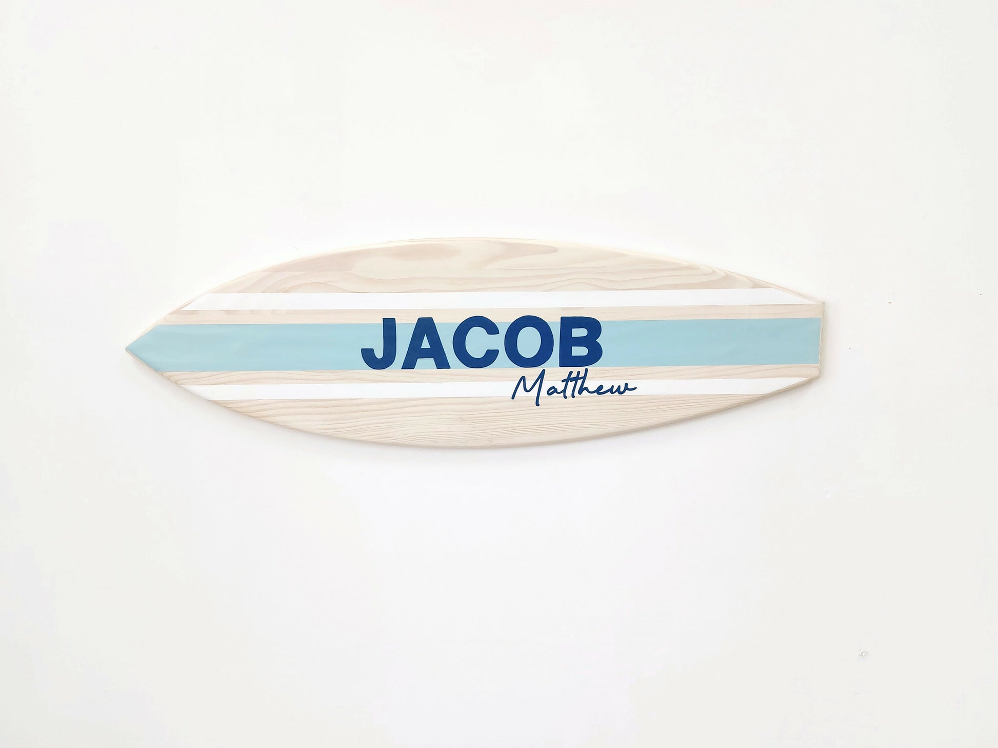 Beach-themed wooden name sign styled in kids’ room