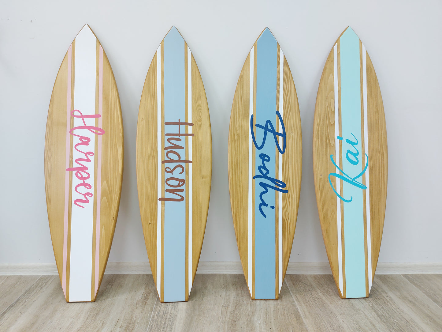 Minimalist nursery decor featuring personalized surfboard wall art