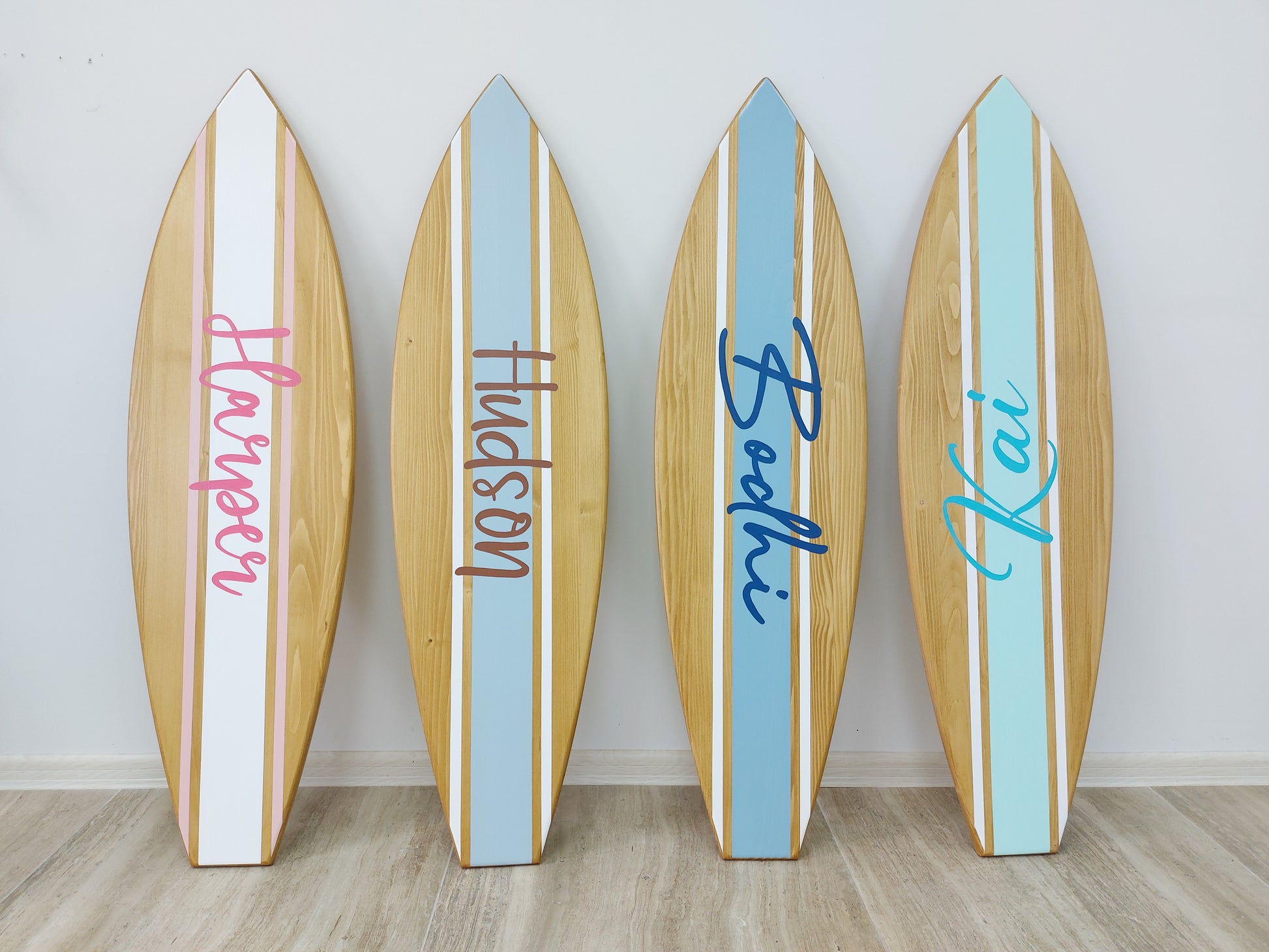 Minimalist nursery decor featuring personalized surfboard wall art
