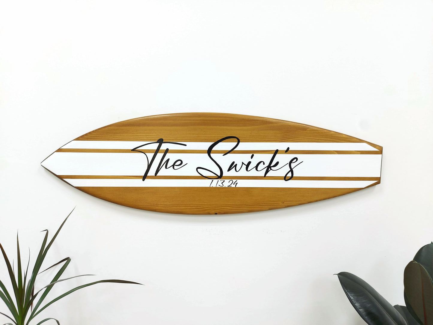 Guests signing on wooden surfboard guest book alternative