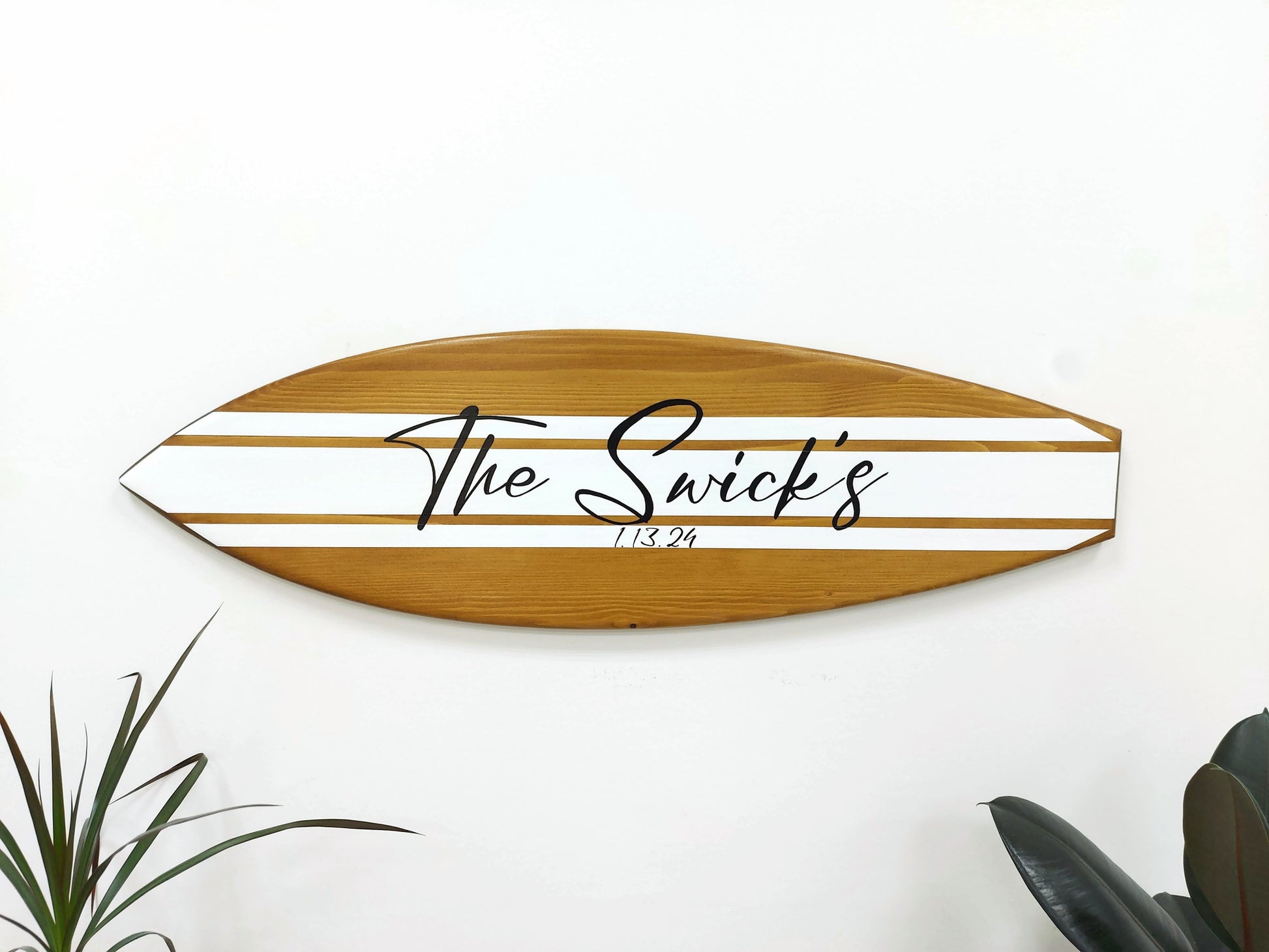 Guests signing on wooden surfboard guest book alternative