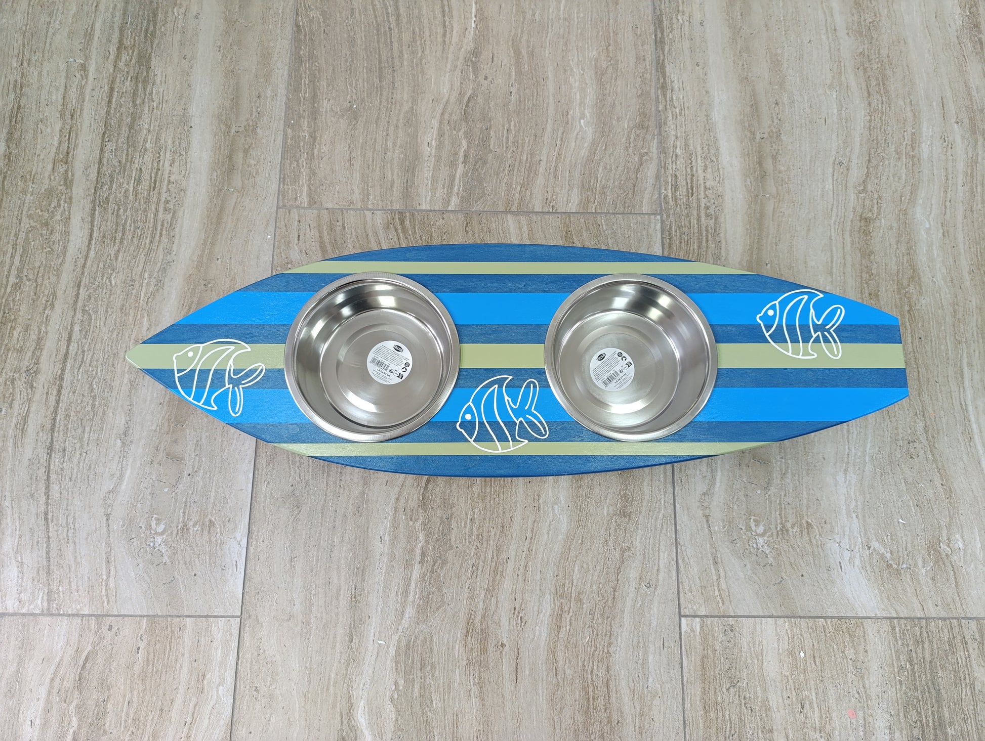 Close-up of custom painting on surfboard-shaped feeding stand