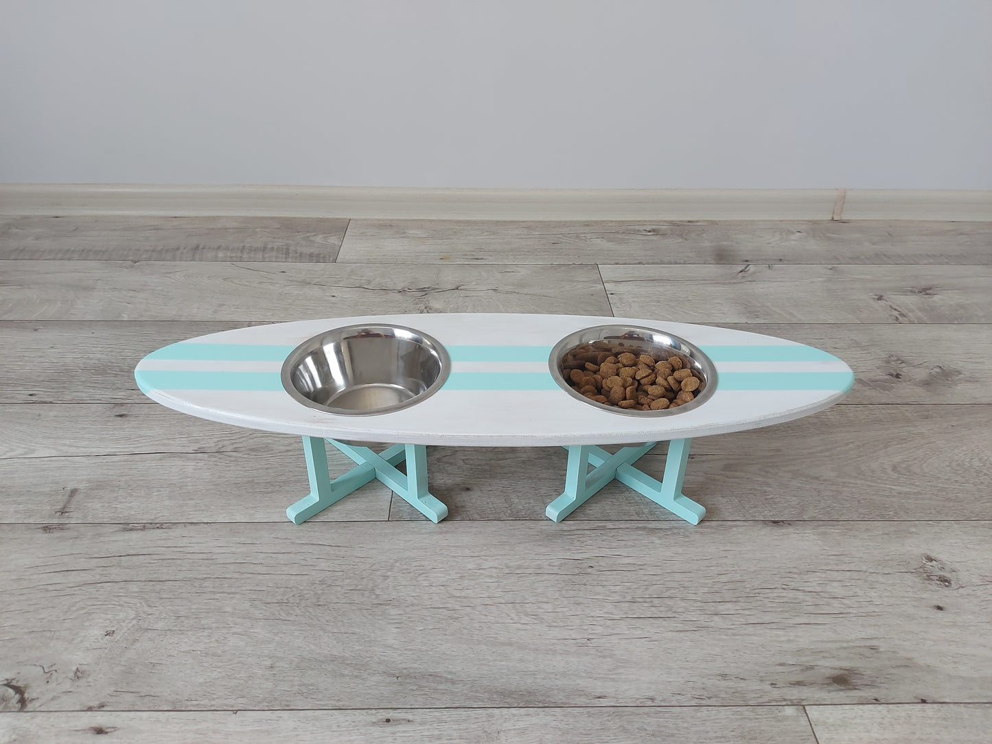 Customly painted surfboard-shaped wooden pet feeding stand