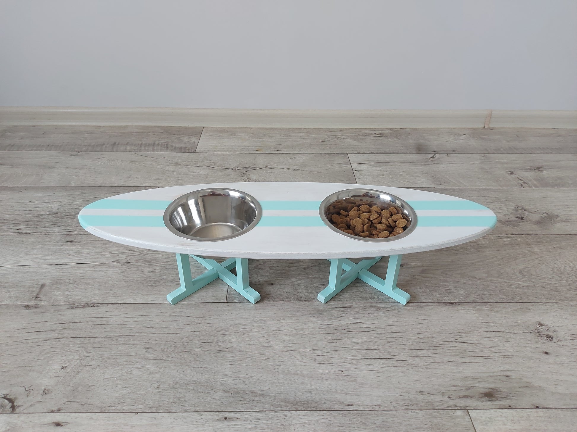 Customly painted surfboard-shaped wooden pet feeding stand