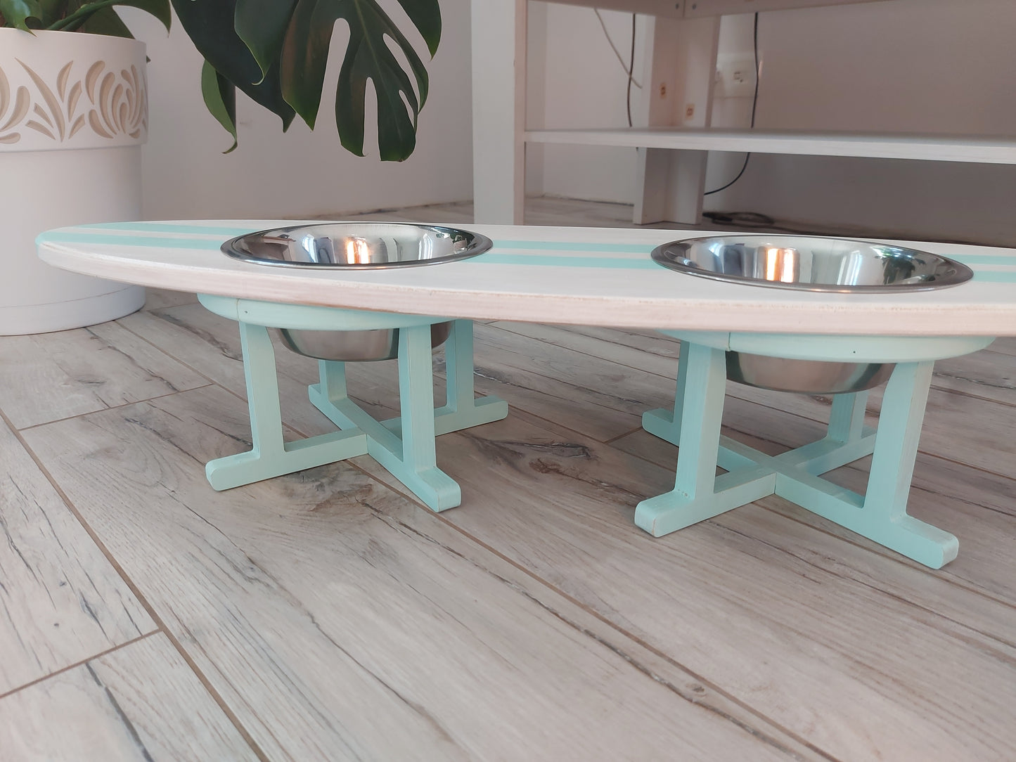 Handmade surfboard feeding station for pets styled in home interior