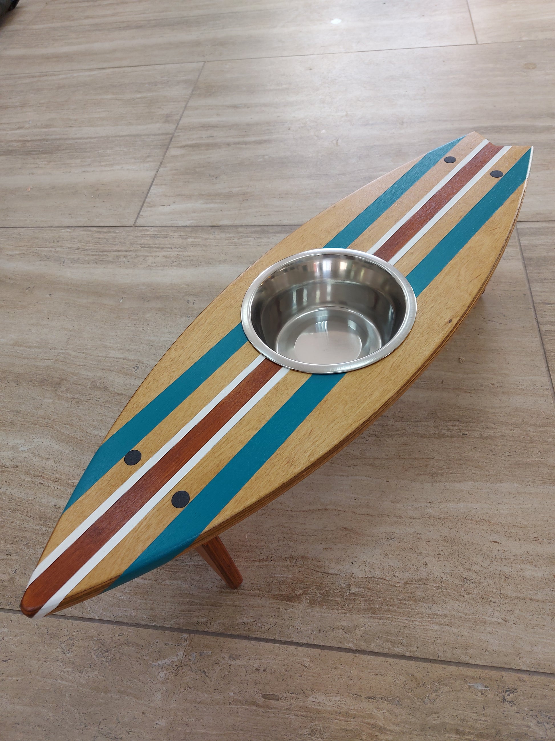 Wooden surfboard bowl station holding one stainless pet bowl