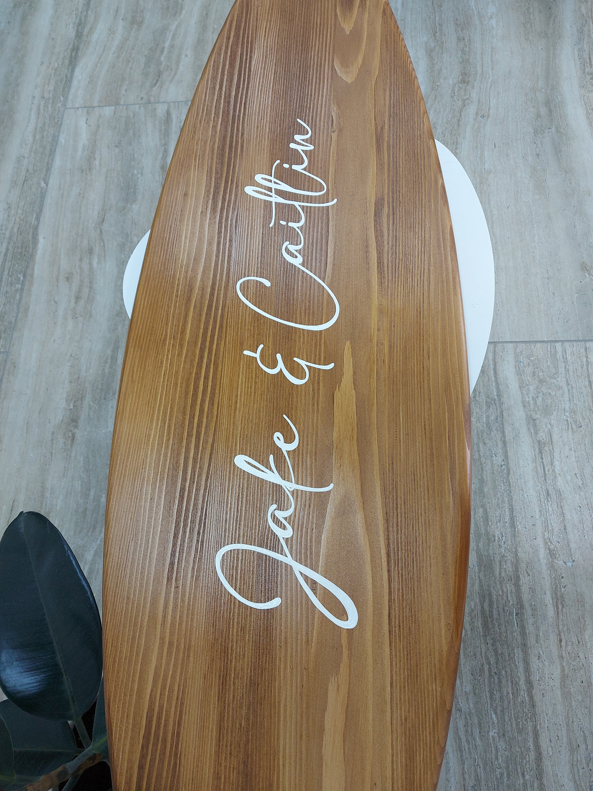 Personalized wooden surfboard wall décor as a wedding guest book with family name design