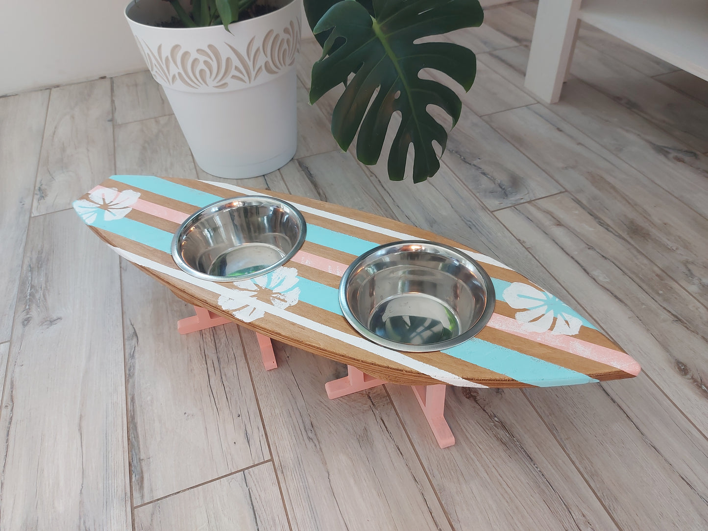 Handmade surfboard dog feeder styled in coastal interior