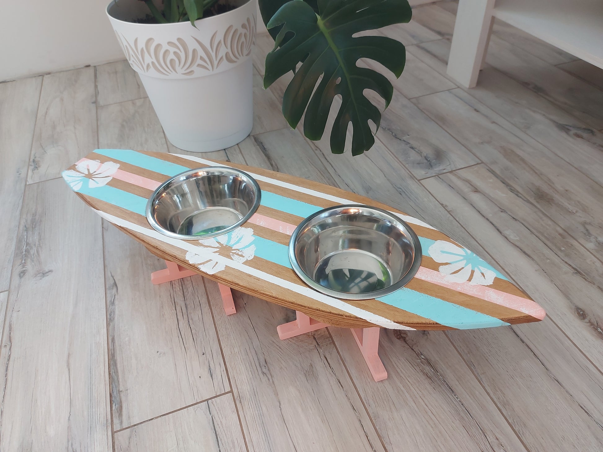Handmade surfboard dog feeder styled in coastal interior