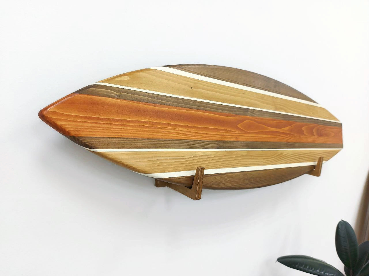 Wooden wall surfboard sign with a modern design on a white wall