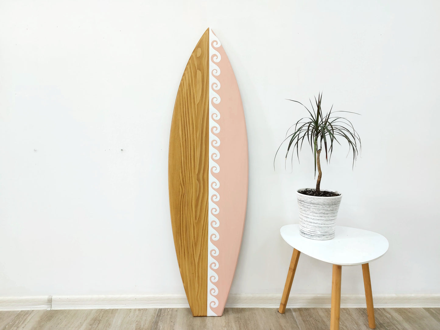 Decorative wooden surfboard wall décor with wave design