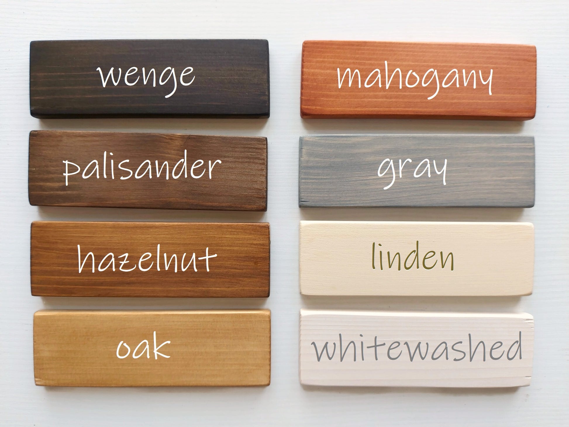 Wooden planks with different finishes and names on a white background