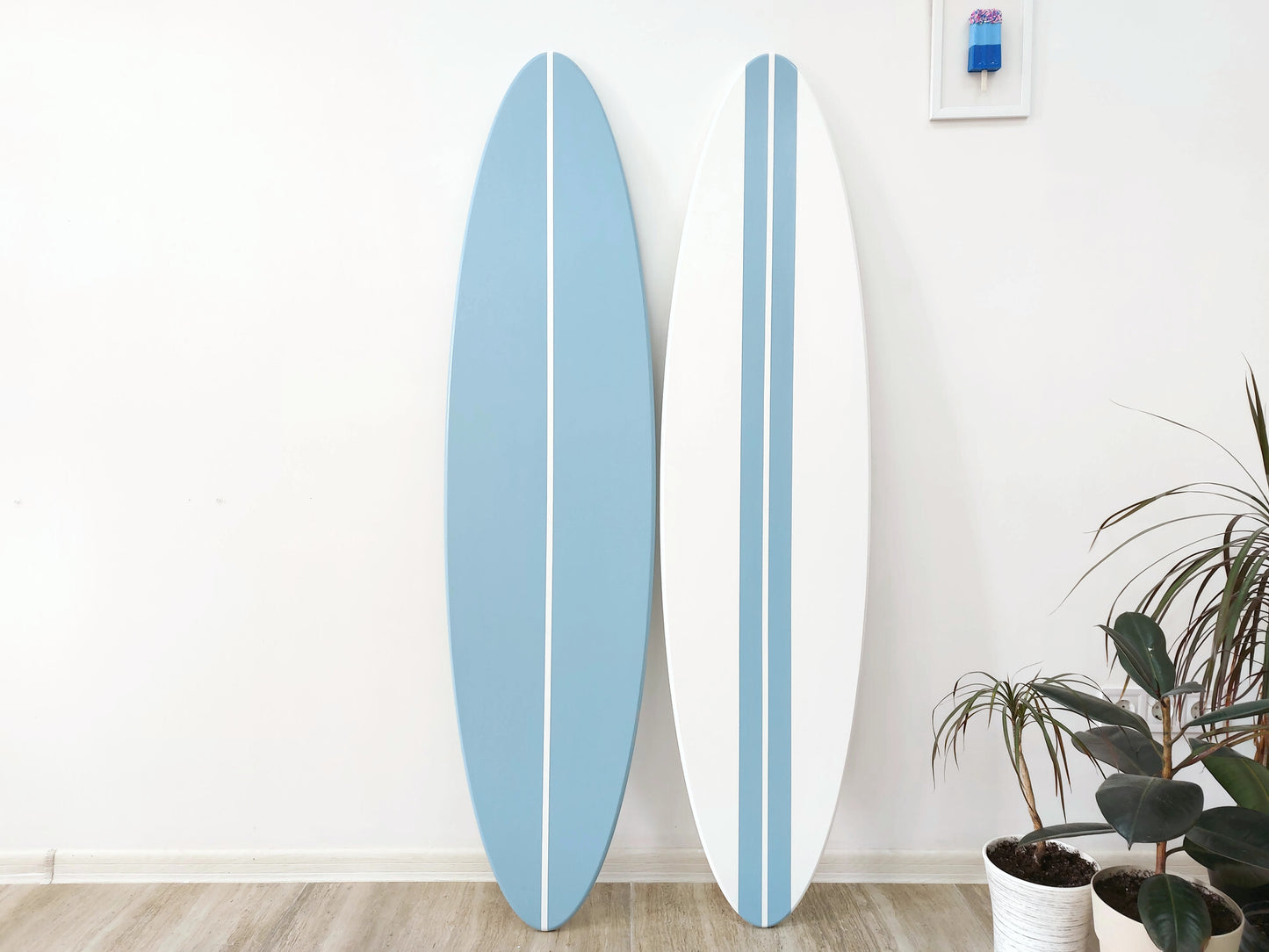 Surfboard wall art in ocean themed room setting