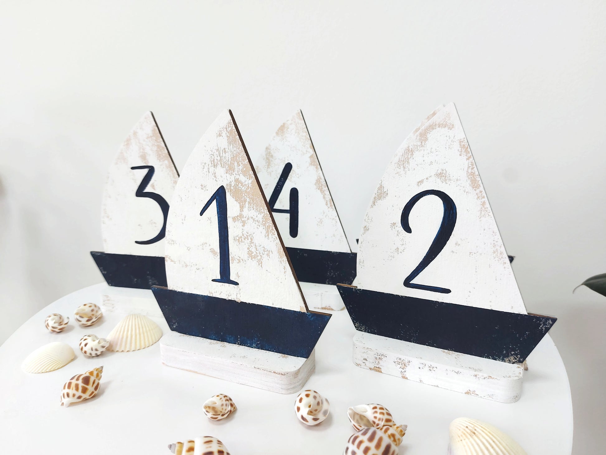 Ocean themed wedding table number set displayed on reception table