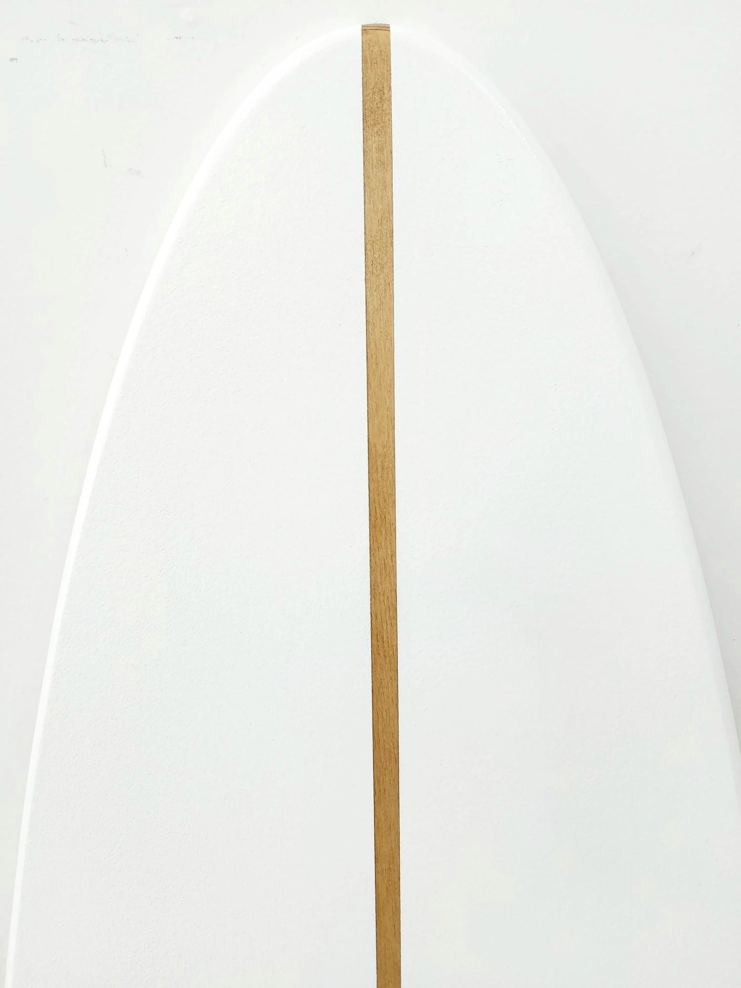 White surfboard sign decor with a vertical brown stripe on a white background
