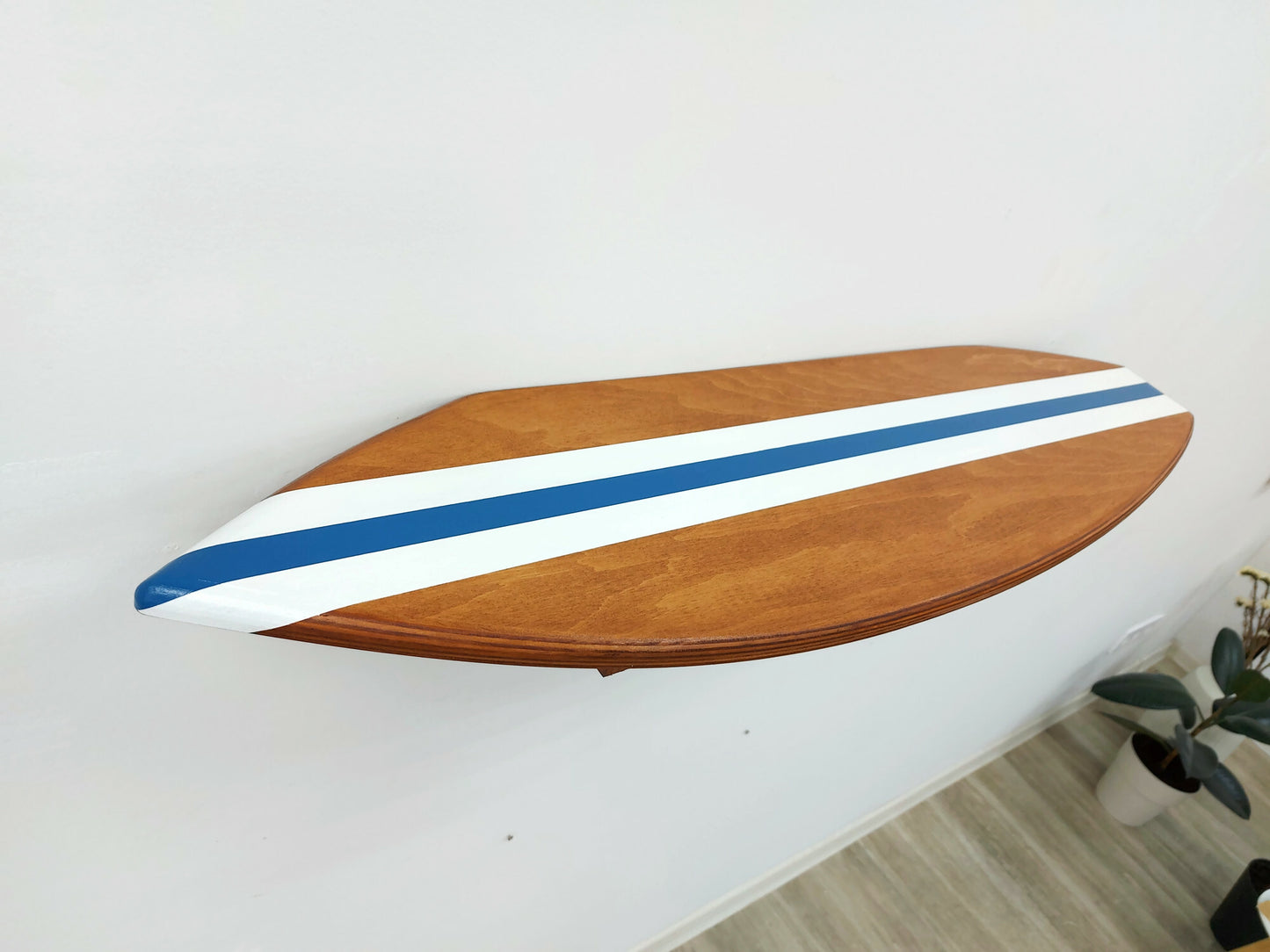 Ocean themed decor wood surfboard floating shelf displayed on wall