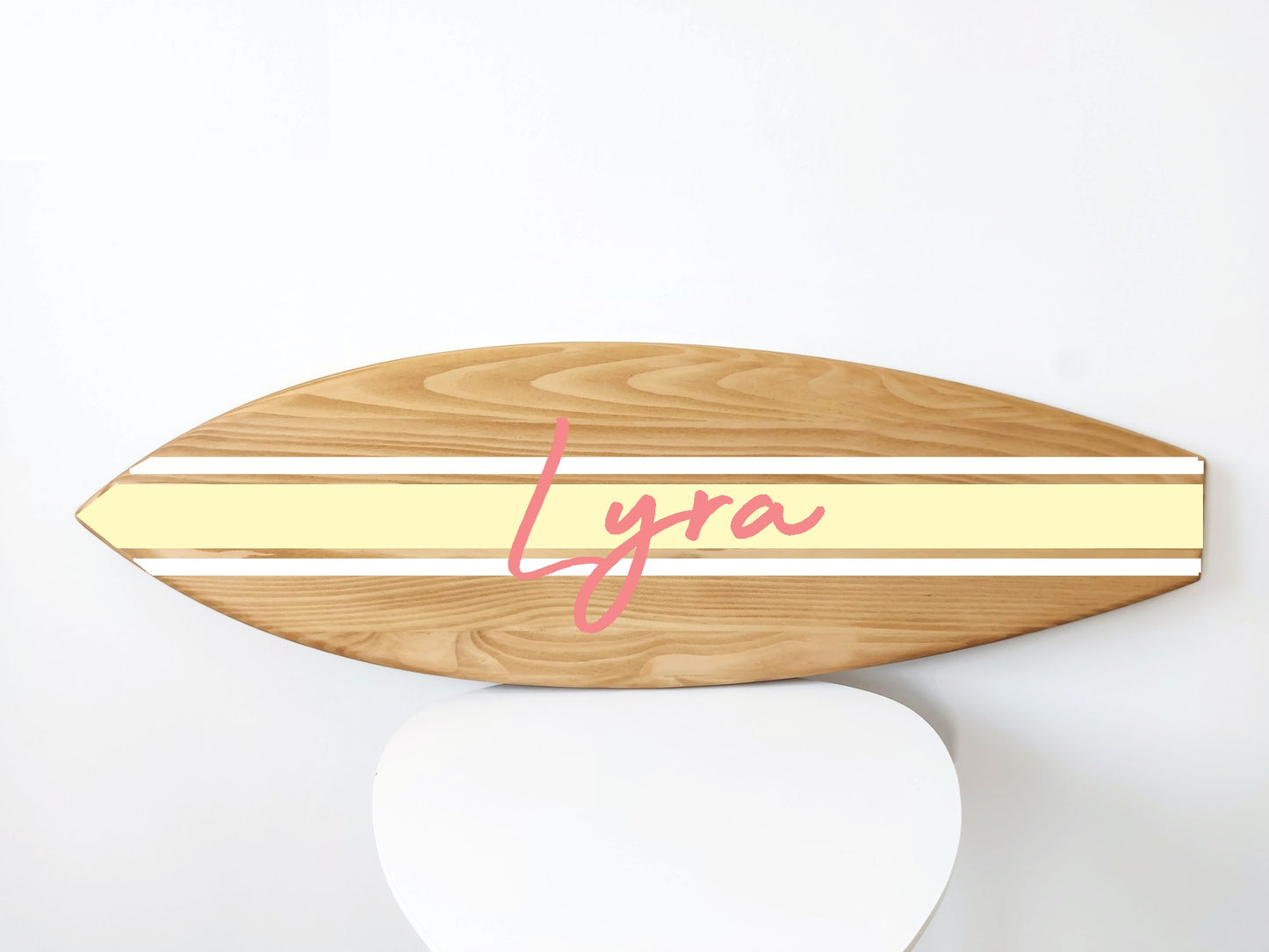 Close-up of engraved name on handcrafted surfboard wall sign