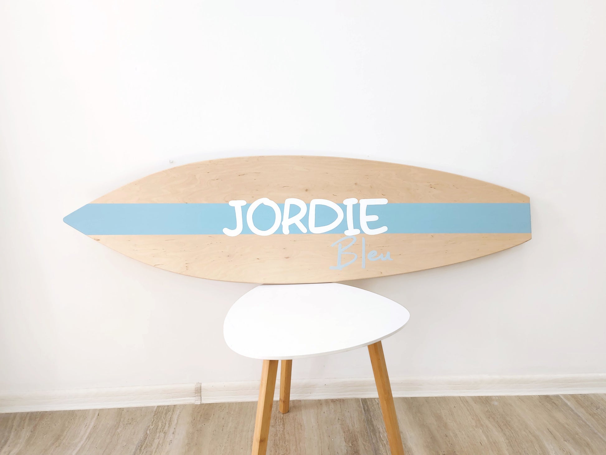 Surf-themed nursery decor with wooden baby name plaque
