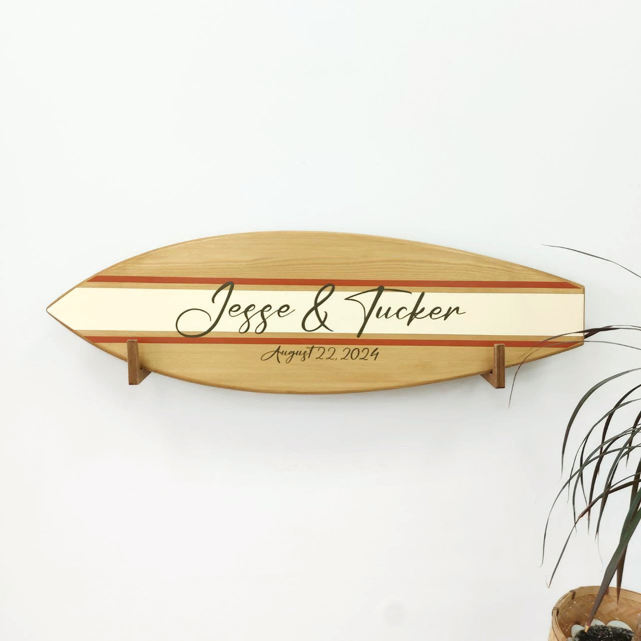 Handmade wooden guest book surfboard displayed at reception