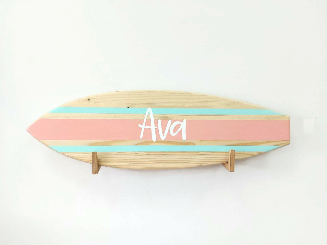 Surf-themed wooden name sign styled in nursery or beach home